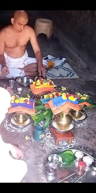 Purohit performing a pooja with kalasha and offerings